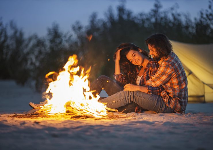 couple-camping-near-campfire-2MQLDSX-1.jpg